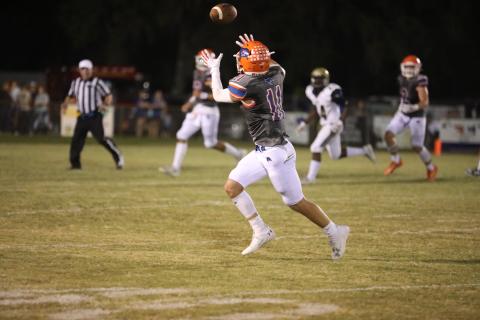 Branford wide receiver Austin Malaguti hauls in a pass Friday night against Paxon. (ERIN ROBERTS/Special to the Reporter)