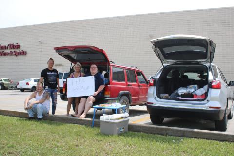 Curtis Handy, Jordana Smith, Daniels Cornuet and Haley Piercey gather outside Winn-Dixie on Friday where they were offering free hot meals to area residents following Hurricane Idalia. (TONY BRITT/Lake City Reporter)