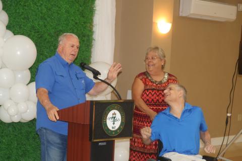 Gary Campbell (from left) addresses the audience at the United Way of Suwannee Valley fundraising kickoff event while accompanied by Beverly Standridge and his son, Michael Campbell. (TONY BRITT/Lake City Reporter)