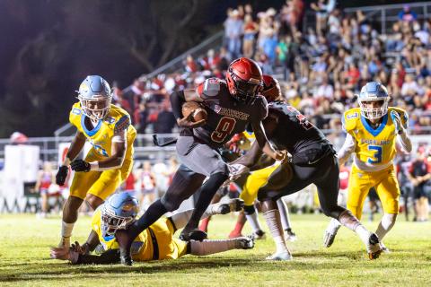 Lafayette quarterback Tywan Williamson leaves a pair of Chiefland defenders behind him on a touchdown run Friday night at Dale Walker Field. (JACK HOWDESHELL/Special to the Reporter)