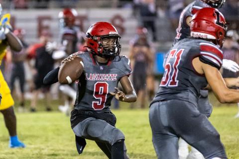 Lafayette quarterback Tywan Williamson scrambles to pass against Chiefland last Friday. (JACK HOWDESHELL/Special to the Reporter)