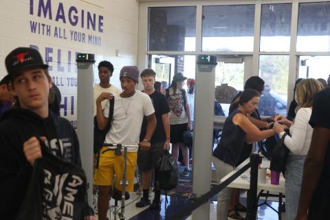 Columbia High School students pass through a metal detector at the front entrance Wednesday morning. (MORGAN MCMULLEN/Lake City Reporter)