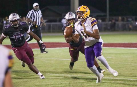 Columbia quarterback Zack Paulk rolls out to pass against Madison County on Friday. (BRENT KUYKENDALL/Lake City Reporter)