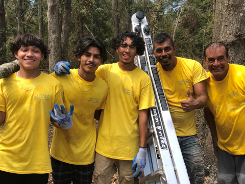 Daniel Mora, Elvis Reynolds, Ammon Reyes, Virginio Mora and Martin Mora are all smiles after helping clear debris from a group of homes for disabled individuals. (COURTESY)
