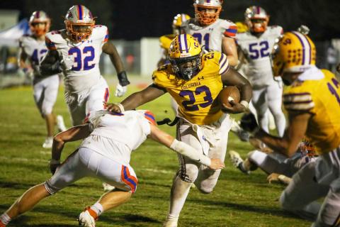 Columbia running back Jonathan Andrews stiff arms a Bolles defender on his game-winning touchdown run Friday night at Tiger Stadium. (BRENT KUYKENDALL/Lake City Reporter)