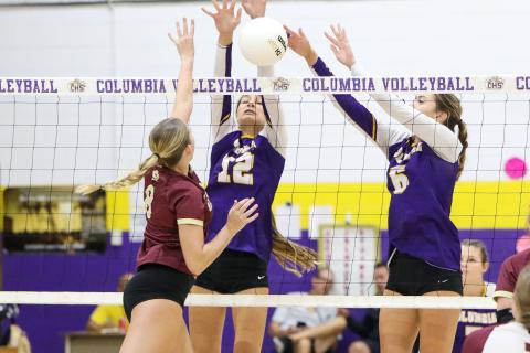 Columbia’s Kayla Goodloe (12) and Sinei Wood (6) attempt to block a shot by Oak Hall hitter Ave Scorpio on Tuesday night. (BRENT KUYKENDALL/Lake City Reporter)