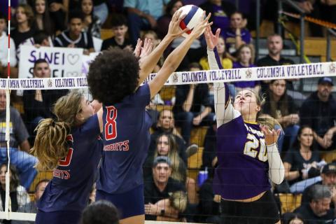 Columbia middle hitter Cassidy O’Neal gets blocked by Vanguard middle hitter Lillian Hart during Tuesday’s District 2-5A semifinal. (BRENT KUYKENDALL/Lake City Reporter)
