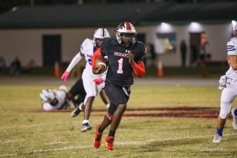 Fort White running back Dakota Fisher runs past the Ridgeview defense last Friday. (BRENT KUYKENDALL/Lake City Reporter)