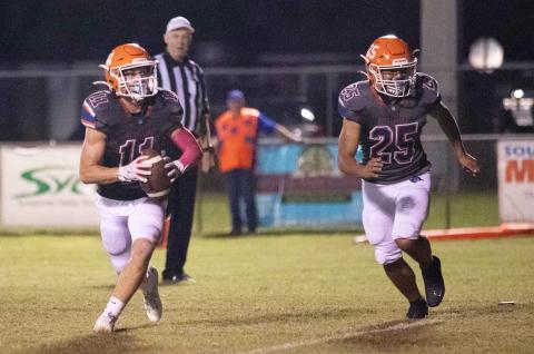 Branford receiver Austin Malaguti runs up the field with the ball alongside kicker Hector Velasquez during last Friday’s game against Hollis Christian Academy. (ERIN ROBERTS/Special to the Reporter)