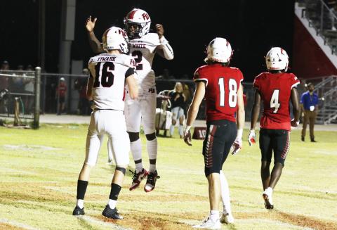 Fort White receiver Najeeb Smith celebrates with receiver Garrett Brady after Brady scored a touchdown against Hilliard on Friday night. (MORGAN MCMULLEN/Lake City Reporter)