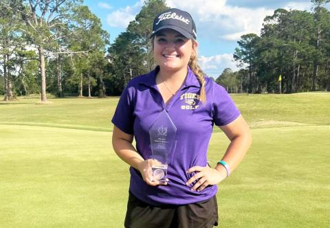 Columbia golfer Karlee Gainey poses with her Region 1-2A championship trophy on Tuesday. (COURTESY)
