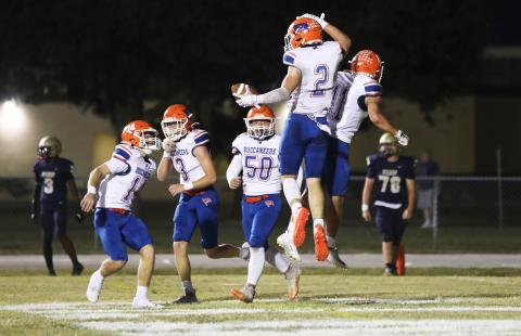 Branford running back Trevor Maddox (2) celebrates with teammates after scoring a touchdown against Bishop McLaughlin Catholic on Friday. (ERIN ROBERTS/Special to the Reporter 