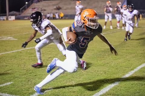 Branford receiver Kyshaun Veasey runs past a Hollis Christian Academy defender on Friday. (ERIN ROBERTS/Special to the Reporter)
