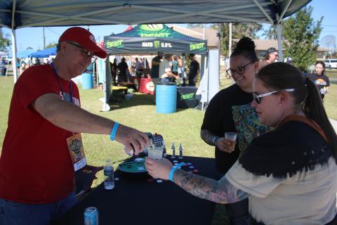 John Kasak (clockwise from left) pours cider for Gateway City Craft Beer and Wine Festival visitors Whitney Martin and Ashley James. (TONY BRITT/Lake City Reporter)