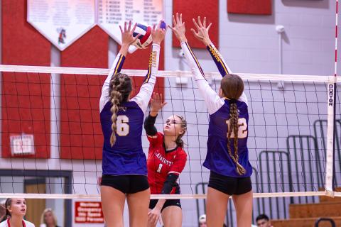 Lafayette hitter Brooke Lamb returns a shot as Columbia hitters Sinei Wood (6) and Kayla Goodloe (12) defend on Oct. 3. (JACK HOWDESHELL/Special to the Reporter)