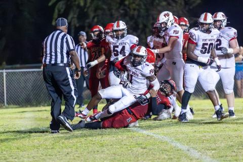 Lafayette defensive back Tywan Williamson (9) tackles Fort White running back Dakota Fisher (1) last Friday. (JACK HOWDESHELL/Special to the Reporter)