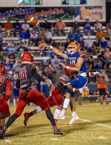 Branford quarterback Thomas Sikes is hit as he throws by Lafayette defensive lineman Amarie Fleming last Friday. (JACK HOWDESHELL/Special to the Reporter)