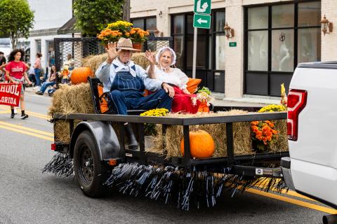 Pioneer Day ‘Granny and Pappy’ Elvoy and Betty Land wave as they serve as the grand marshals of the festival’s parade Saturday in Mayo. (JACK HOWDESHELL/Special to the Reporter)