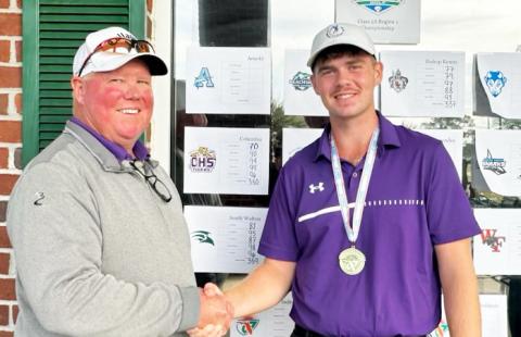 Columbia head coach Sherman Reed (left) shakes hands with Columbia golfer Connor Williams (right) after Williams won the Region 1-2A title on Tuesday. (COURTESY)