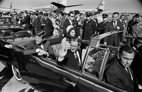 President John F. Kennedy (back left), Jacqueline Kennedy (back right), begin the motorcade from Love Field to downtown Dallas on Nov. 22, 1963. Texas Gov. John Connally is waving. (TOM DILLARD/Dallas Morning News/TNS/file)