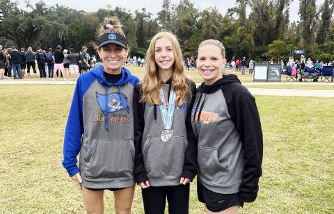 Branford runner Anna Moore (middle) placed 12th at the Class 1A state meet on Friday. Moore is pictured with boys head coach Michelle Richards (left) and girls coach Stefani Santos (right). (COURTESY)