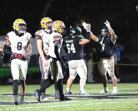Choctawhatchee running back Cole Tabb (3) celebrates after scoring a touchdown as defensive back Markeyon Moore (8), defensive end Ayden Phillips (40) and defensive back Lequawn Johnson (2) look on during Friday's Region 1-3S quarterfinal. (JORDAN KROEGER/Lake City Reporter)