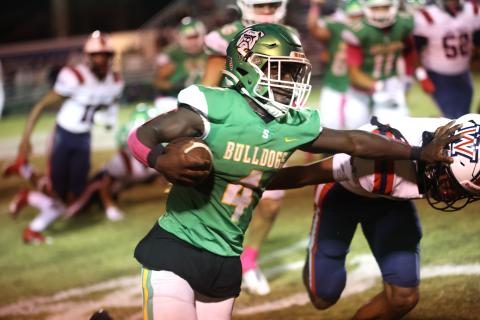 Suwannee running back Marquavious Owens stiff arms a Wakulla defender last Friday. (PAUL BUCHANAN/Special to the Reporter)