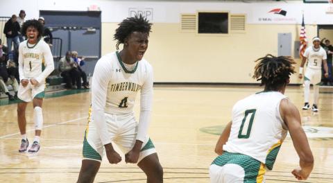 FGC forward Ty’jahn Wright (4) and guard Antewan Webber (1) celebrate after a dunk by Oakley Lewis (0) against Polk State College on Wednesday. (JORDAN KROEGER/Lake City Reporter)