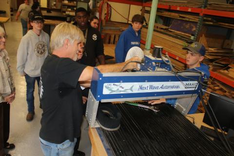 Columbia High Building, Trades and Construction Designs Technology Career Technical Education instructor Scott Dockery shows Carl Pavey one of the computer-navigated woodworking machines in the CHS woodshop Tuesday. (TONY BRITT/Lake City Reporter)