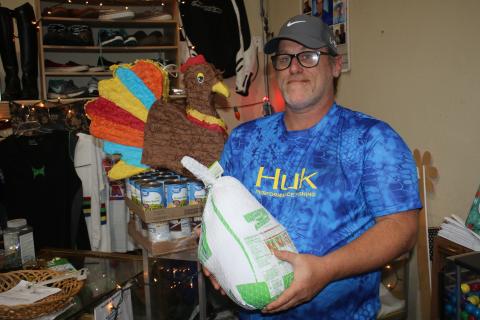 John ‘Lit’ Cole, the president of Kids Feeding Kids, holds one of the turkeys that the organization plans to give to families in need today. (TONY BRITT/Lake City Reporter)