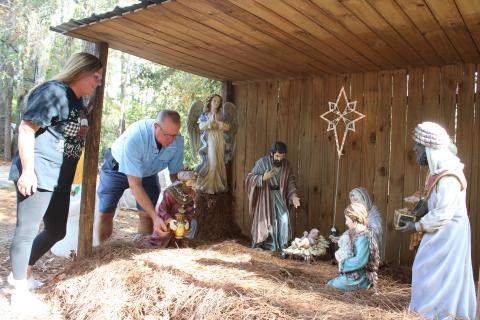 Brad and Lorrie Wheeler finish setting up a nativity scene in their yard Monday. The Wheelers’ Christmas display has become a community draw for the past 27 years at 197 NW Brookside Court. The display officially begins every year on Thanksgiving night. (TONY BRITT/Lake City Reporter)