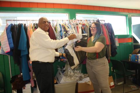 Philip Mobley (left), NorthStar Family Resource Center executive director, hangs clothing at the facility in January with help from Christen Lancaster, NorthStar Community Center Community Research Coordinator. (FILE)