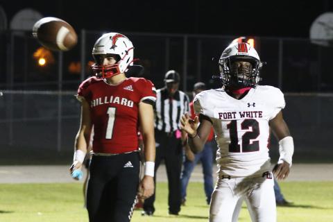 Fort White receiver Najeeb Smith flips the ball to the referee after scoring a touchdown against Hilliard last Friday. (MORGAN MCMULLEN/Lake City Reporter)
