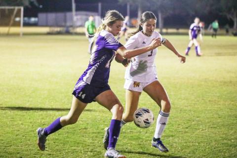 Columbia’s Mia Brasel fights for possession of the ball with Florida High’s Olivia Talevich on Friday. (BRENT KUYKENDALL/Lake City Reporter)