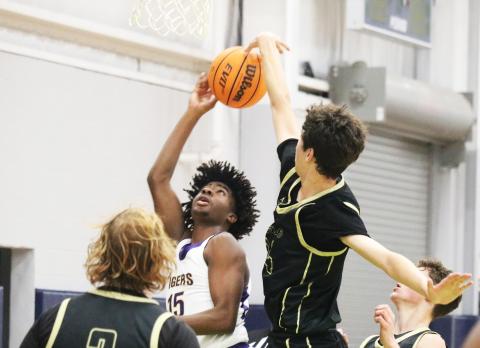 Nease center Jack Sullivan (right) blocks Columbia forward Zavian Douglas’ shot during the Hitchcock’s Challenge on Wednesday. (JORDAN KROEGER/Lake City Reporter)