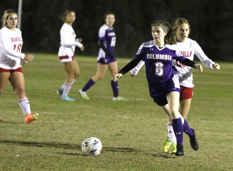 Columbia's Nikki Sossie dribbles past Wakulla's Brianna Stephens in the first half of Thursday's matchup. (MORGAN MCMULLEN/Lake City Reporter)
