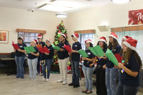 Fort White High School National Honor Society members sing Christmas carols while visiting the Robert H. Jenkins Veterans Domiciliary on Sunday afternoon. (TONY BRITT/Lake City Reporter)