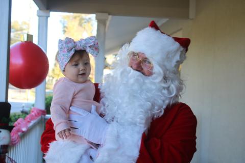 Santa Claus visits with Adeline Sage, six months old, on Tuesday afternoon at the Pregnancy Care Center. (TONY BRITT/Lake City Reporter)