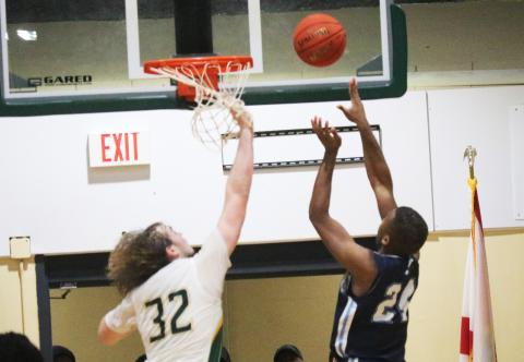 Santa Fe forward Makye Boles makes a putback at the buzzer over FGC forward Axel Holmquist on Thursday. (JORDAN KROEGER/Lake City Reporter)