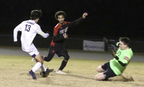 Columbia’s Bergen Cobb (13) dribbles into the box against Fort White’s Jared Hopkins and Colt Patterson during Thursday’s game. (MORGAN MCMULLEN/Lake City Reporter)