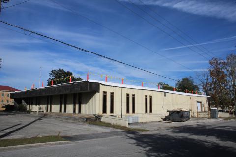 O’Neal Roofing is working on the roof of the old Lake City Reporter building, which Columbia County purchased earlier this year. (TONY BRITT/Lake City Reporter)