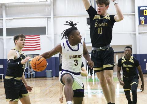 Columbia guard Zamarion Jones passes around Buchholz forward Gabe Thompson during the Hitchcock’s Challenge on Friday. (JORDAN KROEGER/Lake City Reporter)