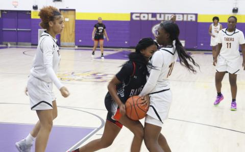 Columbia guard Ayesha Broxey (right) boxes in a Baker County dribbler in the backcourt as guard Mariah Cox comes over to help during Tuesday’s game. (MORGAN MCMULLEN/Lake City Reporter)