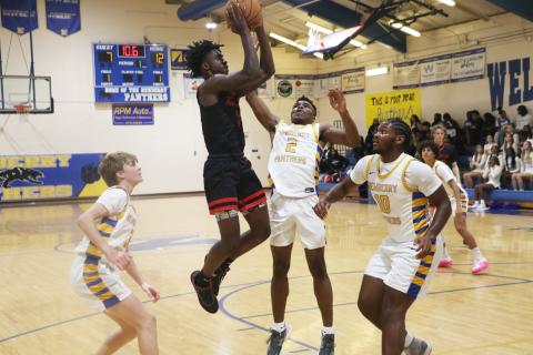 Fort White guard Jayden Jackson shoots over Newberry’s Kaleb Woods (2) and Logan McCloud (10) on Wednesday. (MORGAN MCMULLEN/Lake City Reporter)