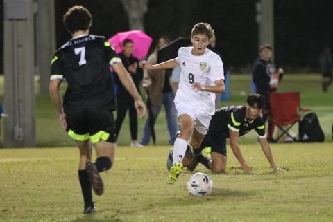 Lincoln’s Gavin Poucher dribbles past Columbia’s Diego Garcia on Friday. (JORDAN KROEGER/Lake City Reporter)