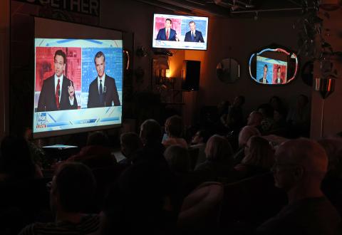 People watch a debate between California Gov. Gavin Newsom and Florida Gov. Ron DeSantis during a watch party at Manny’s on Thursday in San Francisco. Newsom and DeSantis were hosted by Sean Hannity on Fox. (JUSTIN SULLIVAN/Getty Images/TNS)