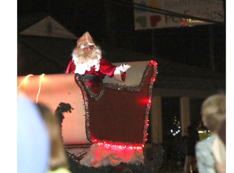 Santa Claus rides in the Live Oak Christmas parade last year. This year's parade, which was originally scheduled for Dec. 2, has been moved again to Friday due to inclement weather forecast Saturday. (FILE)