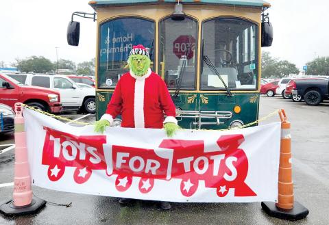 The Grinch made an appearance Saturday at the Suwannee County Toys for Tots’ ‘Stuff The Bus’ toy drive at Walmart in Live Oak. (COURTESY)