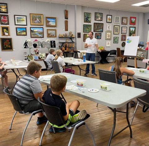 Jeffrey Moore (standing), a Gateway Art Gallery member, instructs Junior Youth Art League class  students during a recent session. (COURTESY)