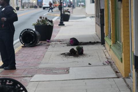 Flowers from a planter that adorns the side of North Marion Avenue lay on the ground after a suspect vandalized six of the city pots early Tuesday morning. (JAMIE WACHTER/Lake City Reporter)
